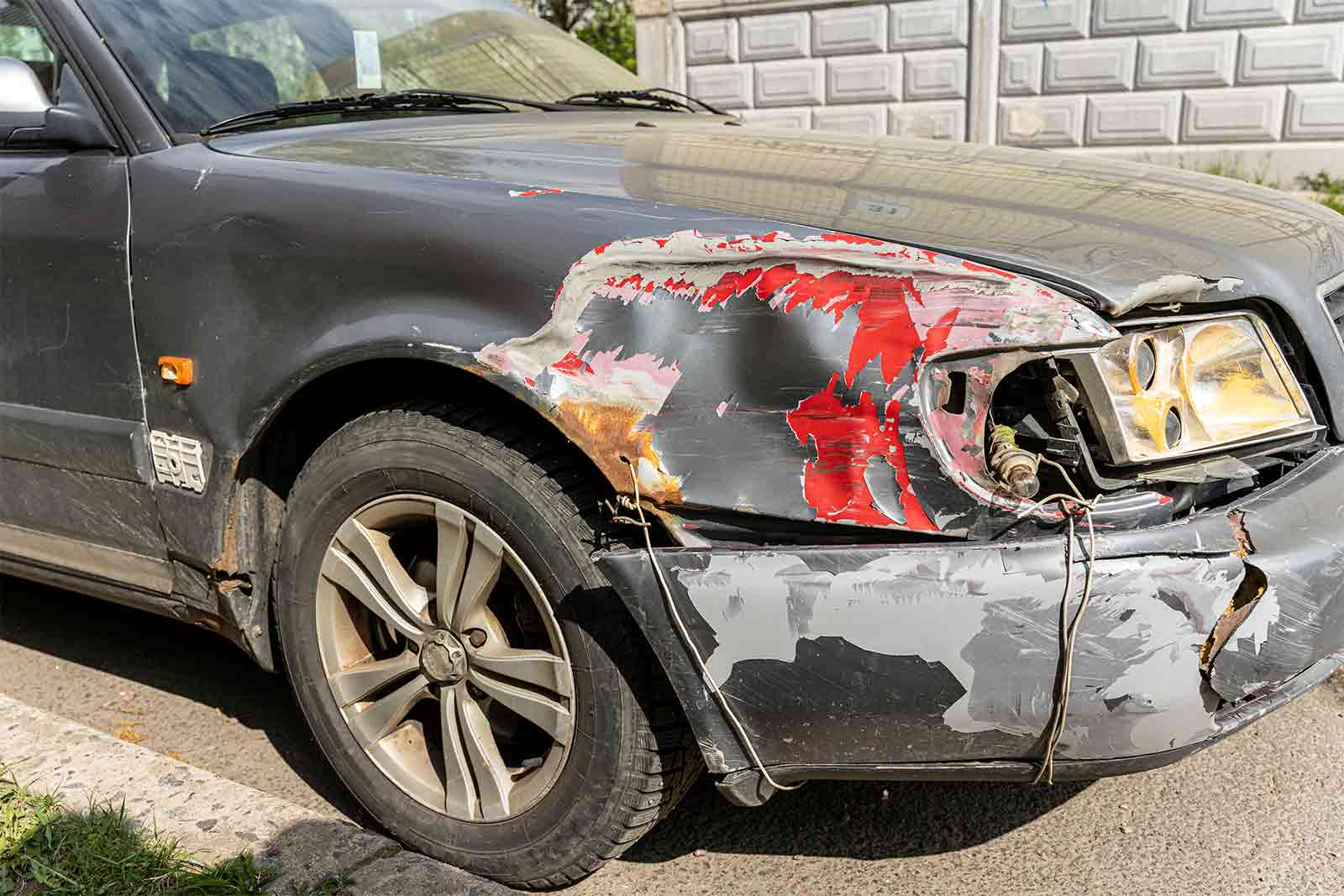 A car with a crumpled front end after a collision
